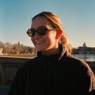 Person wearing sunglasses with a scenic background