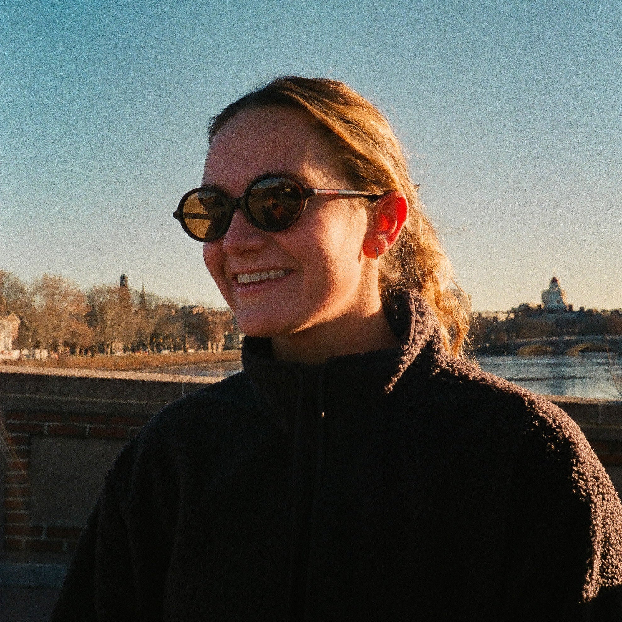 Person wearing sunglasses with a scenic background